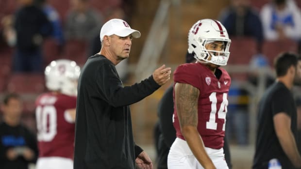 Oct 21, 2023; Stanford, California, USA; Stanford Cardinal head coach Troy Taylor (left) and quarterback Ashton Daniels (14) walk on the field before the game against the UCLA Bruins at Stanford Stadium. Mandatory Credit: Darren Yamashita-USA TODAY Sports